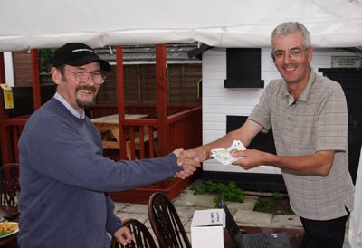 David Bourne receives his pools winnings from Neil